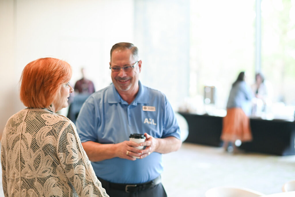 League Field Rep Jackie Crabtree chats with a guest.