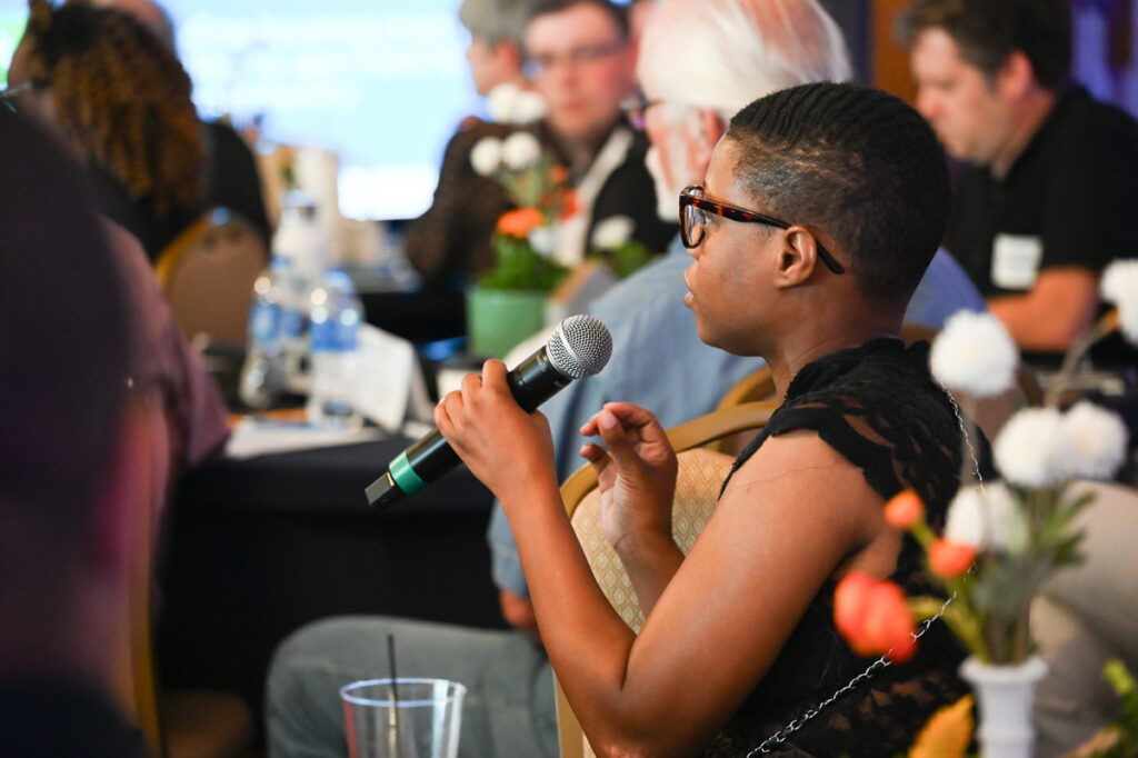 A regional meeting attendee asks a question of the event's speaker.