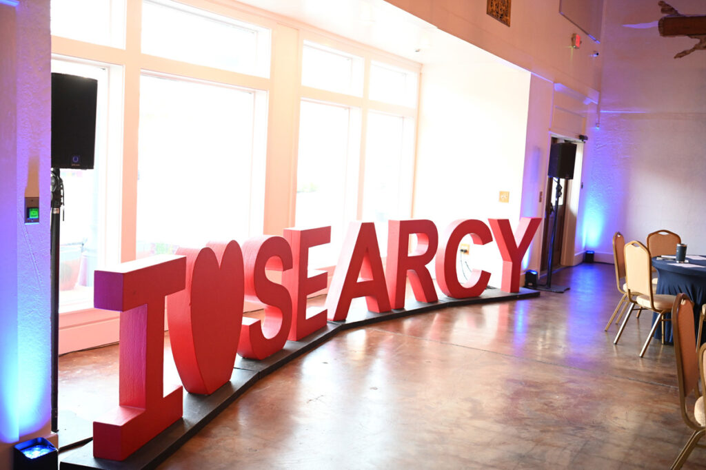 A I LOVE SEARCY sign at the entry of the meeting. The sign is red and made of wood, with a heart for the word "love."