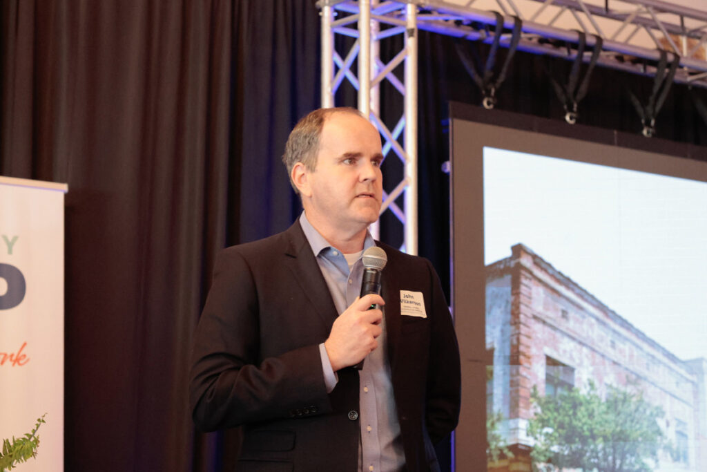 League General Counsel John Wilkerson speaks on stage at a regional meeting.